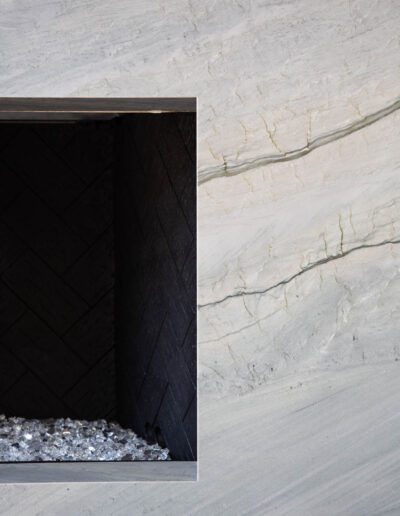 A geometric shadow cast within an angular recess in a textured wall.