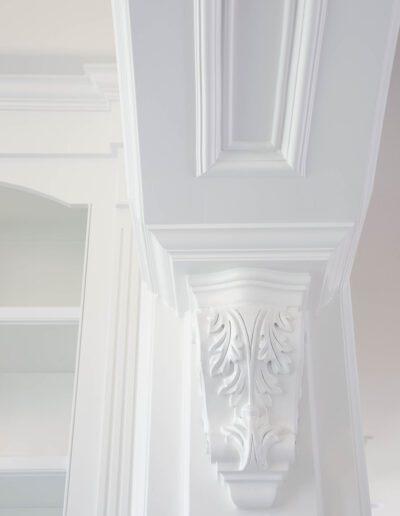 Elegant white architectural detail featuring crown molding and an ornate corbel.