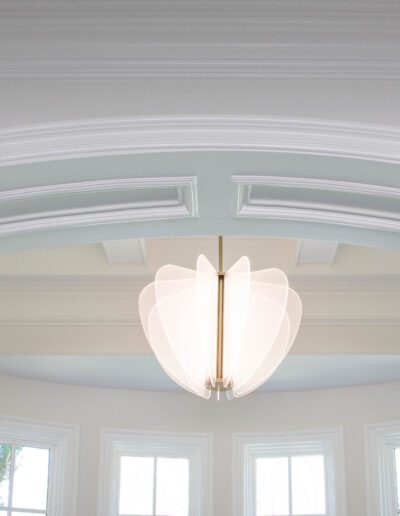 Elegant interior with a modern chandelier and white crown molding.